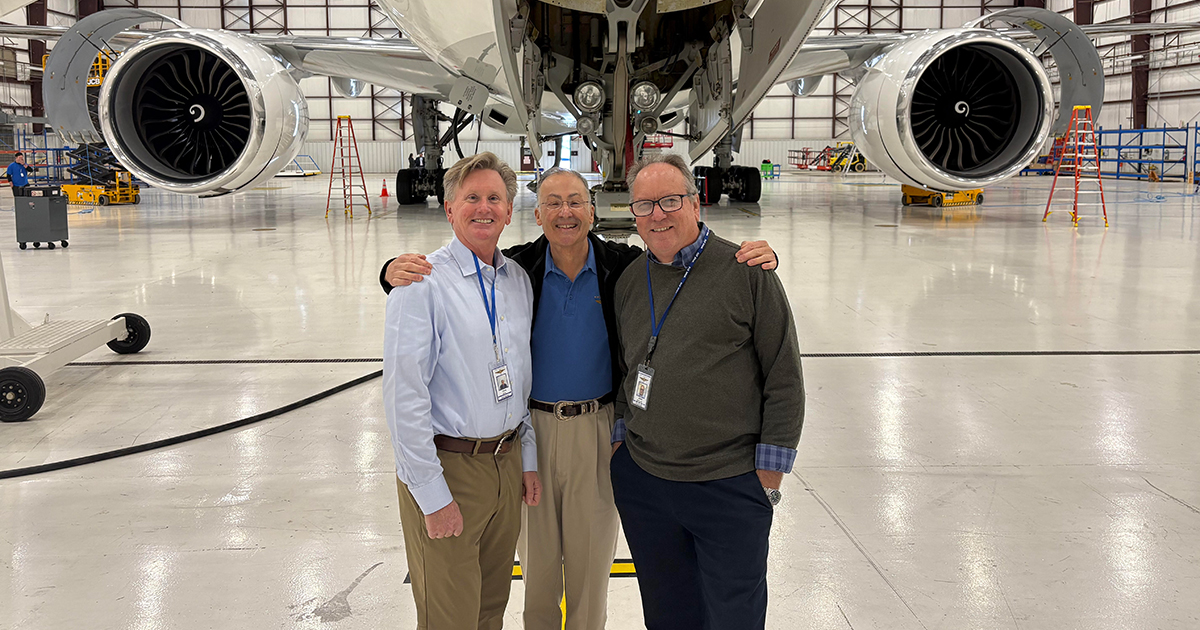 Chris Mason and John McWilliam pose in front of an aircraft with Mr. King as they work on a new project together